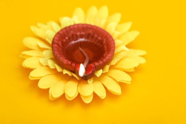 Concept of indian festival diwali Traditional oil lamps on yellow background