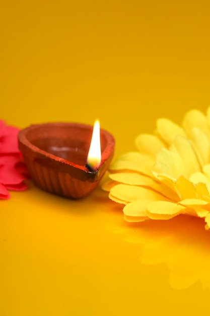 Concept of indian festival diwali Traditional oil lamps on yellow background