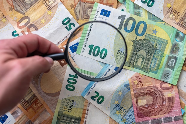 Concept of inflation in Europe euro money with magnifying glass