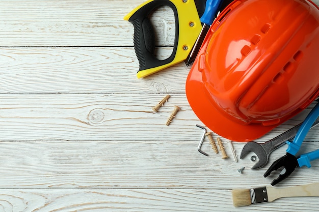 Concept of Labor Day with different construction tools on white wooden