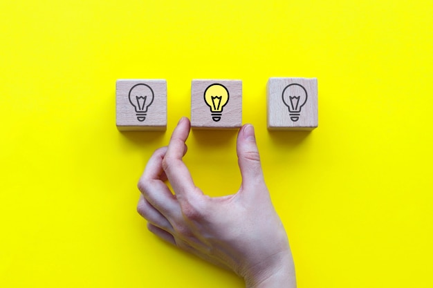 Concept of a new idea, wooden cubes with a light bulb icon