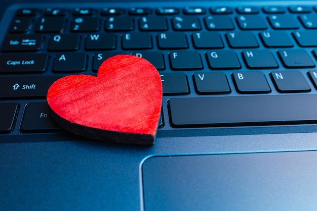 Photo concept online datingonline date heart on laptop computer keyboardcloseup