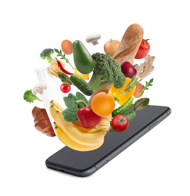 concept of online store food delivery Vegetables milk bread falling into a smartphone