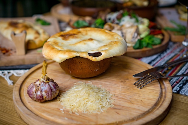 The concept of oriental cuisine. Homemade georgian Uzbek pilaf or plov from lamb served in cast iron cookware