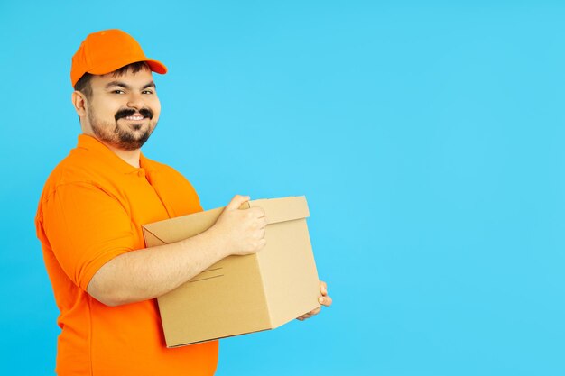 Concept of people fat delivery man with box on blue background