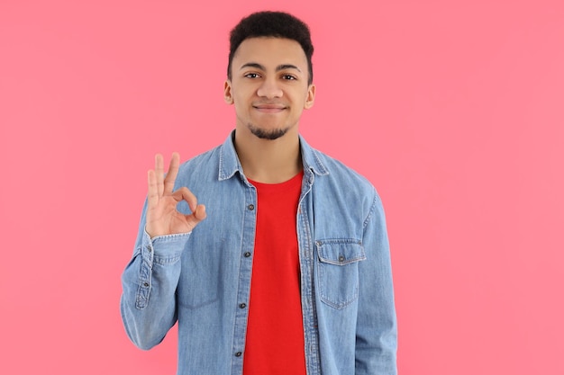 Concept of people with young man on pink background