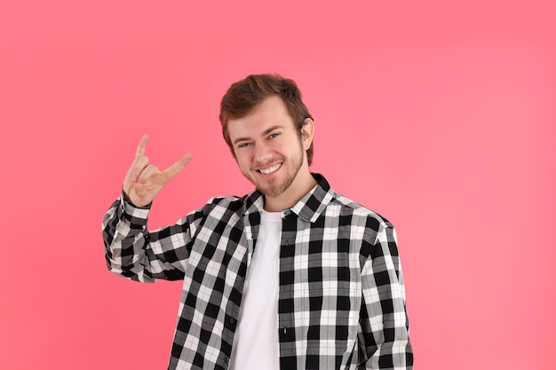 Concept of people with young man on pink background