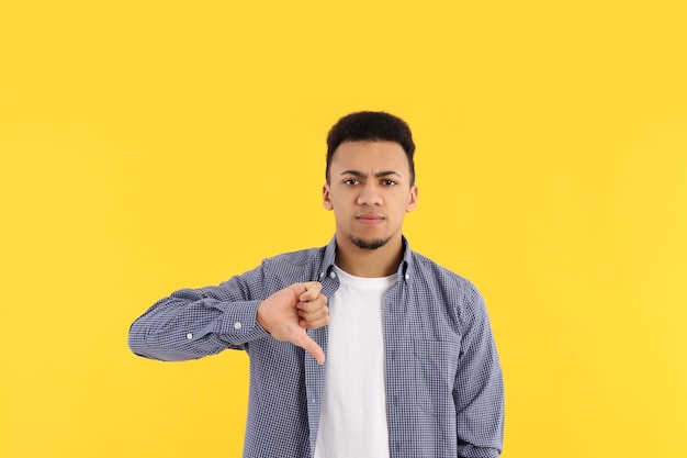 Concept of people with young man on yellow background