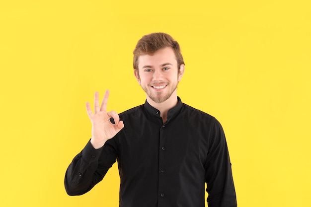 Concept of people with young man on yellow background