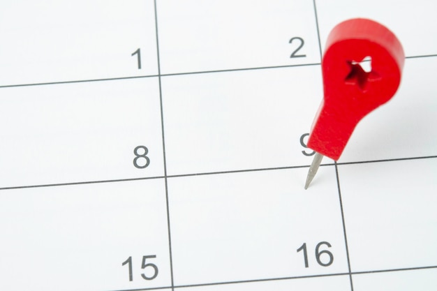 The concept of planning and deadline with push pin on calendar date