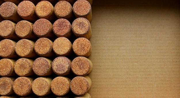 Concept for postcard or background of wine corks on a cardboard with empty part of photo