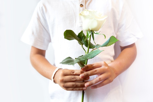 The concept of the protest in Belarus.сMan with white bracelet holding white flower