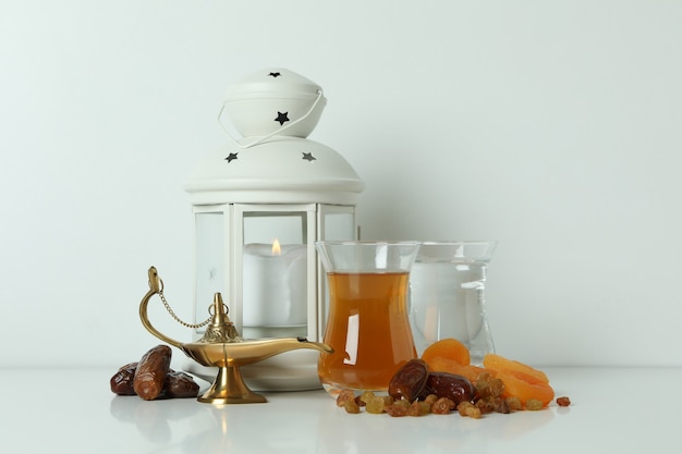 Concept of Ramadan with food and accessories on white