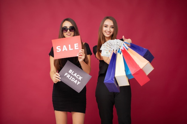 Concept of sales and discounts girls holding packages with new purchases