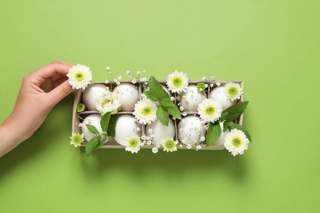 Concept of spring eggs with flowers top view