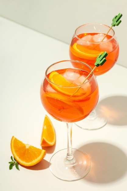 Concept of summer alcohol drink Aperol Spritz on white table