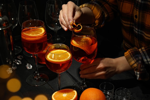 Concept of summer cocktail female bartender making Aperol Spritz