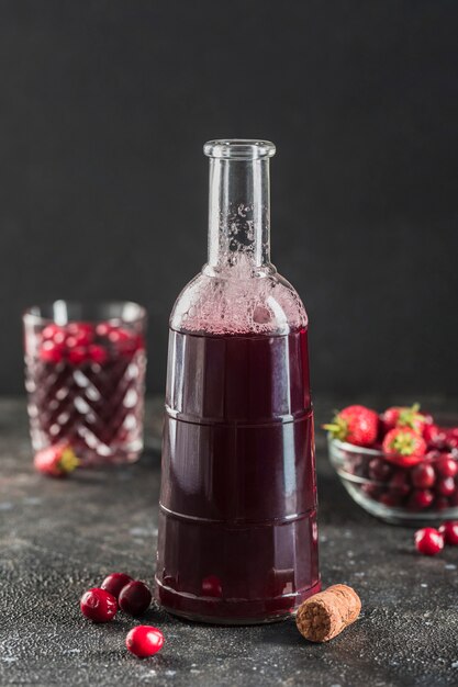 The concept of a summer refreshing drink from red berries: berry Morse of fresh strawberries and cranberries