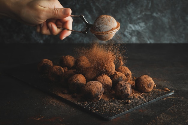 Concept of sweets with truffles on dark textured table