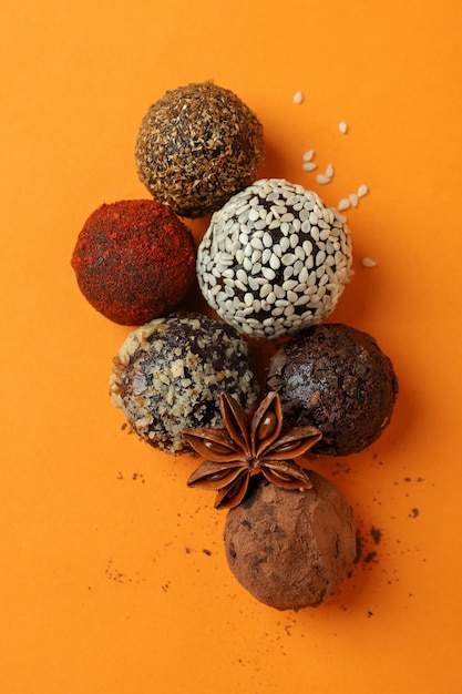 Concept of sweets with truffles on orange background