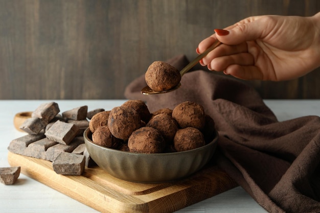 Concept of sweets with truffles on white wooden table