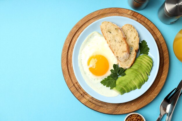 Concept of tasty breakfast on blue background