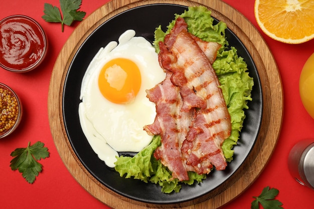 Concept of tasty breakfast on red background