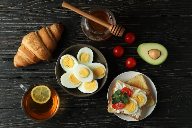 Concept of tasty breakfast with boiled eggs on wooden table