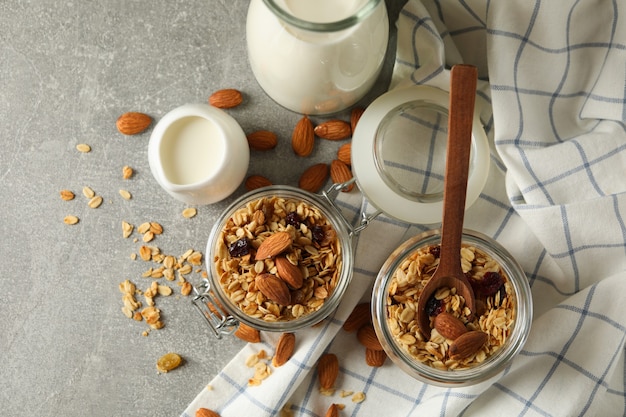 Concept of tasty breakfast with granola on gray background