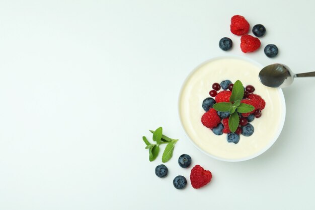 Concept of tasty breakfast with yogurt on white background