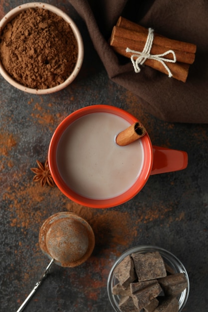 Concept of tasty drink with cocoa on dark background