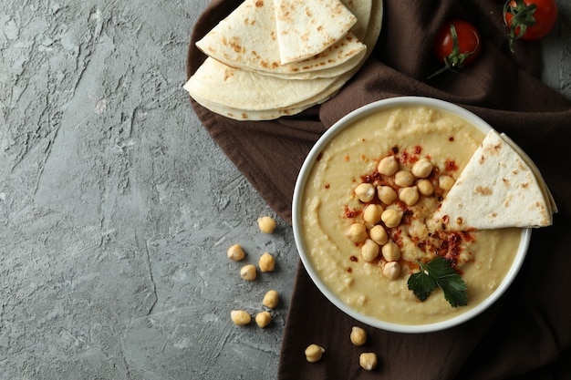 Concept of tasty eat with hummus and pita, space for text