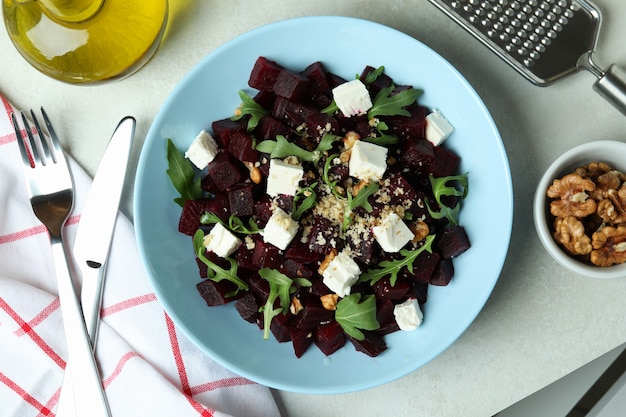 Concept of tasty eating with beet salad on white textured table