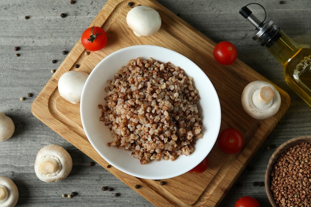 Concept of tasty eating with buckwheat on gray textured table