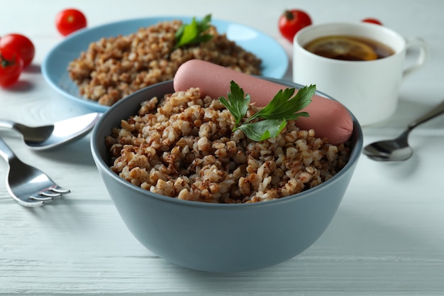 Concept of tasty eating with buckwheat on wooden table