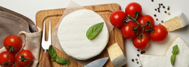 Concept of tasty eating with camembert and spices on white background, top view