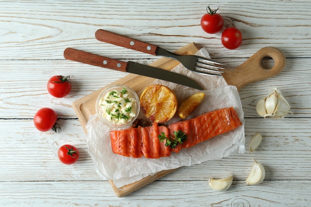 Concept of tasty eating with grilled salmon, top view