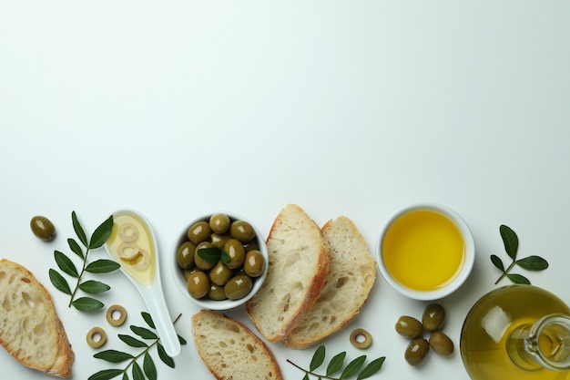 Concept of tasty eating with olive oil on white surface