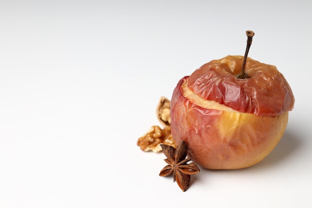 Concept of tasty food with baked apple on white background