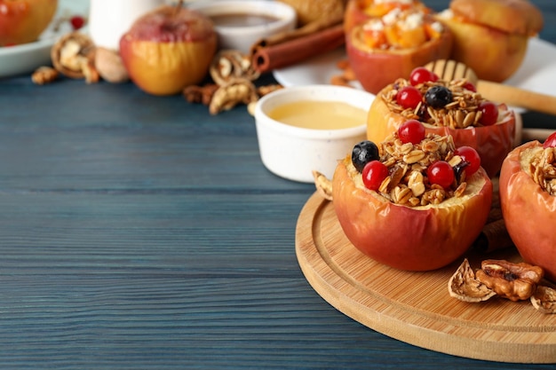 Concept of tasty food with baked apple on wooden background