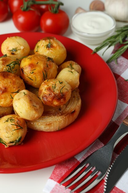 Concept of tasty food with baked potato on white background.