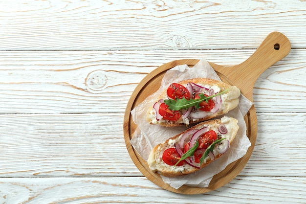 Concept of tasty food with bruschetta snacks on white wooden table