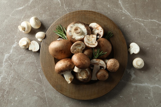 Concept of tasty food with champignon on gray textured background