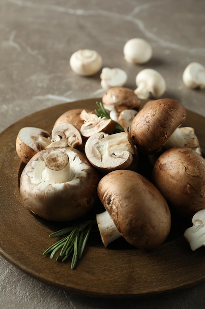 Concept of tasty food with champignon on gray textured background