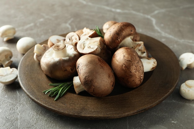 Concept of tasty food with champignon on gray textured background