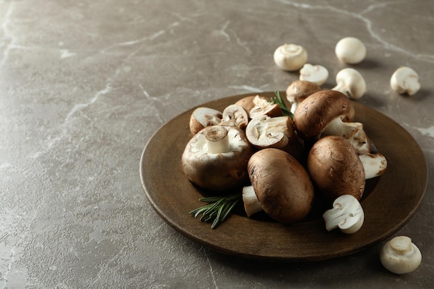 Concept of tasty food with champignon on gray textured background