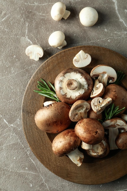 Concept of tasty food with champignon on gray textured background