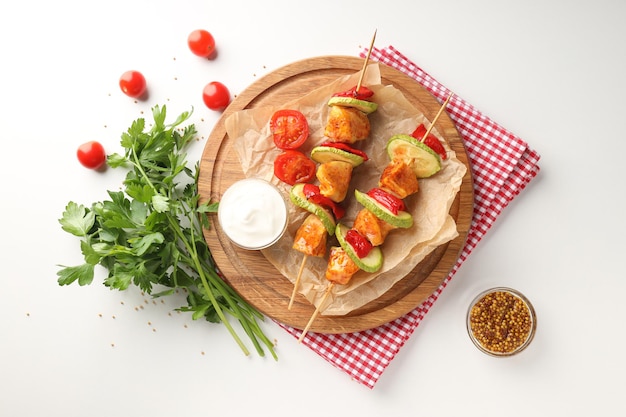 Concept of tasty food with chicken shashlik on white background