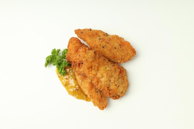 Concept of tasty food with chicken strips on white background