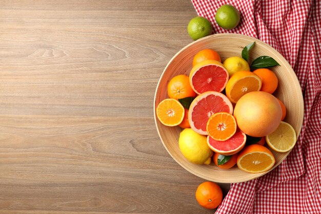 Concept of tasty food with citrus fruits on wooden background